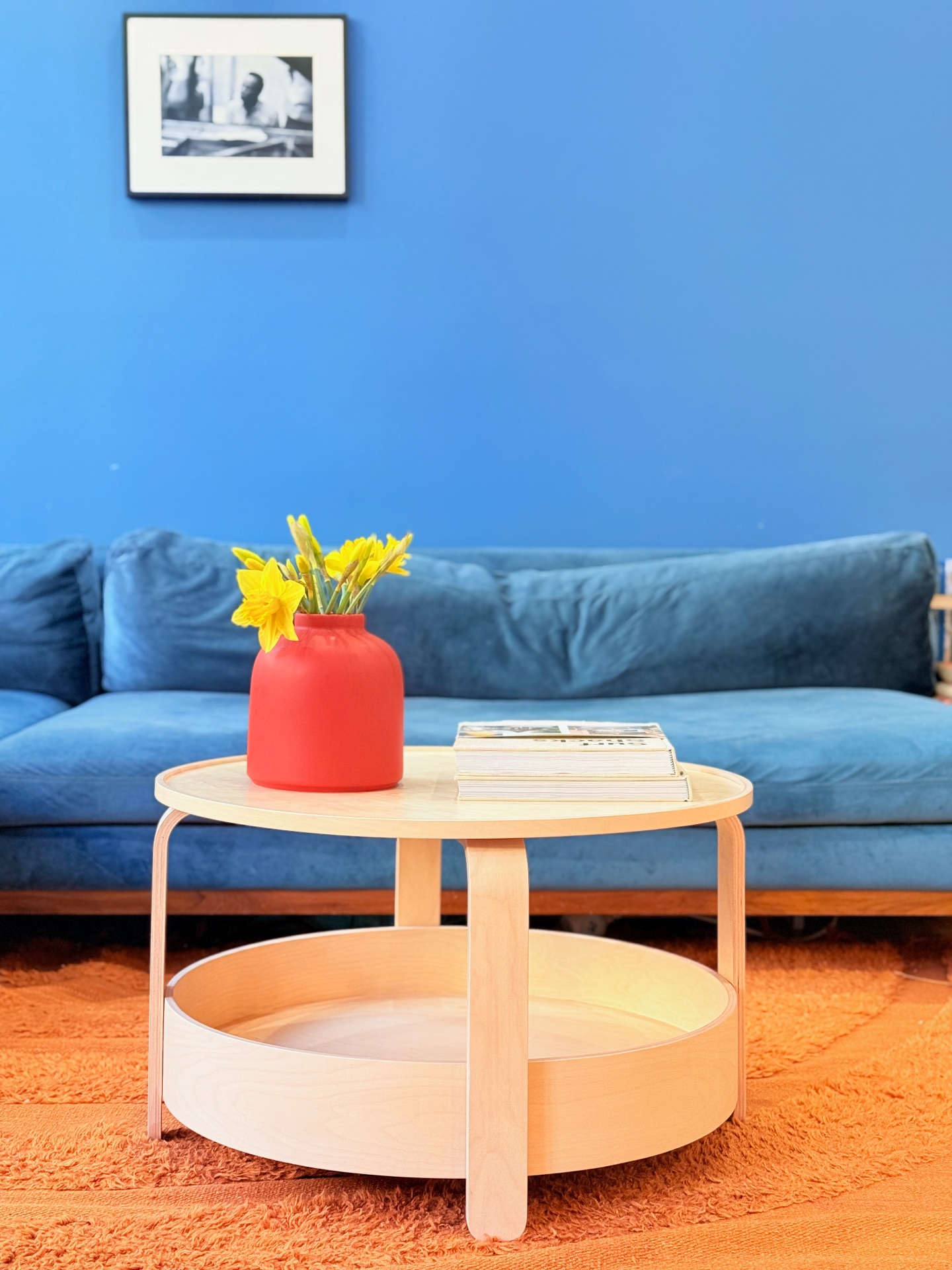 Blue velvet sofa with coffee table